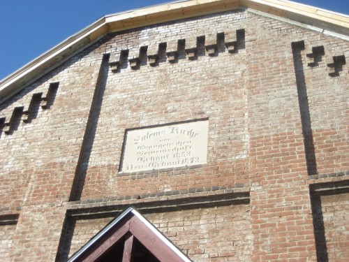 Detail over entry.  Roughly translated "SALEM CHURCH OF THE EVANGELICAL COMMUNITY  BUILT 1853 REBUILT 1873 "